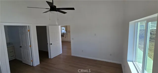 a view of hallway with wooden floor