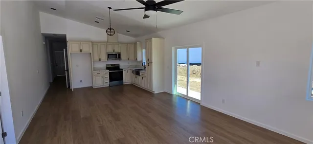 a view of a kitchen with a sink and a refrigerator