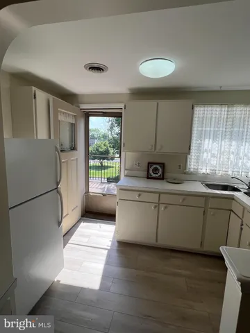 a kitchen with a refrigerator and a sink
