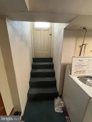 a view of kitchen with sink stove and refrigerator
