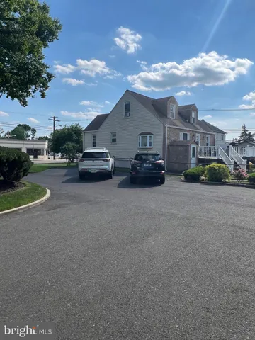a car parked in front of a white house