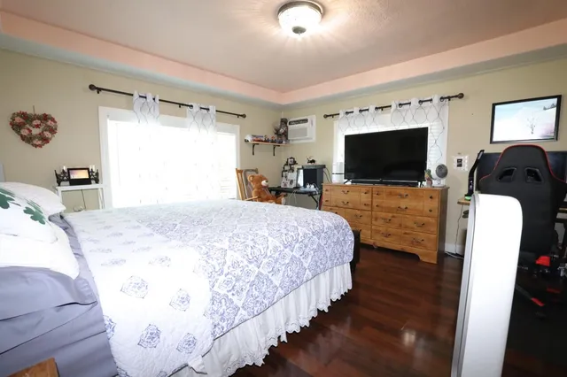 a bedroom with bed and tv