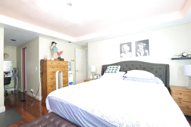 a spacious bedroom with a bed and a table