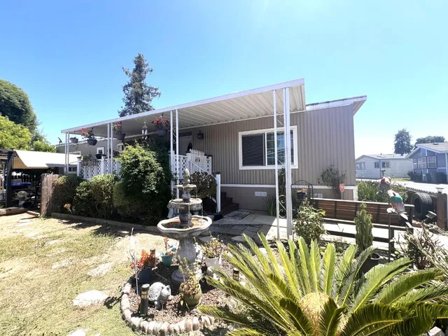 a view of a backyard with plants and patio
