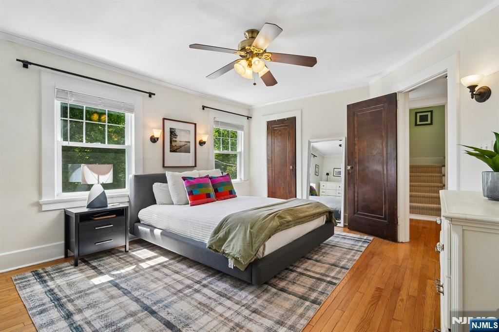 72 Central Avenue Montclair, NJ 07042 - Photo 16 of 36 a bedroom with a bed and a chandelier