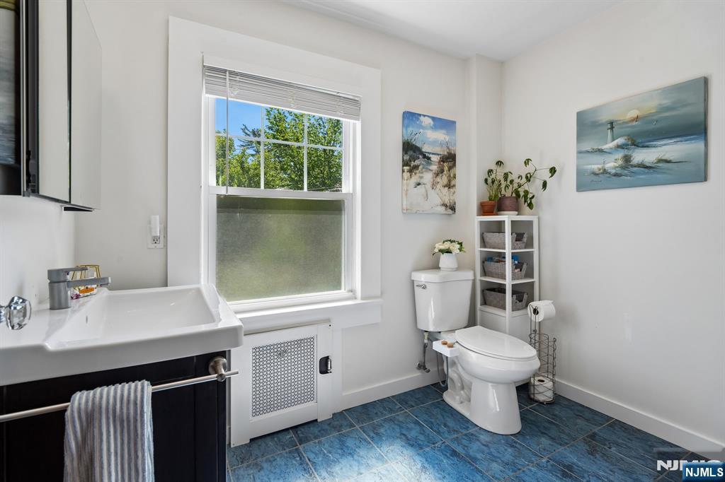 72 Central Avenue Montclair, NJ 07042 - Photo 24 of 36 a bathroom with a toilet a sink and a window