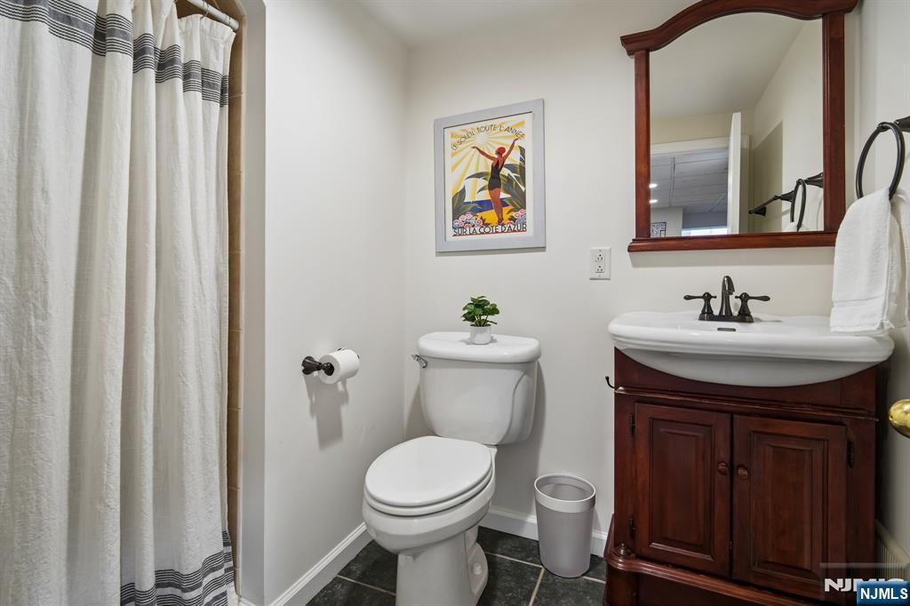 72 Central Avenue Montclair, NJ 07042 - Photo 29 of 36 a bathroom with a sink a toilet and mirror