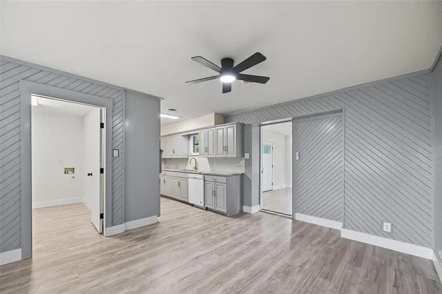 a view of a kitchen with a sink and cabinet with wooden floor