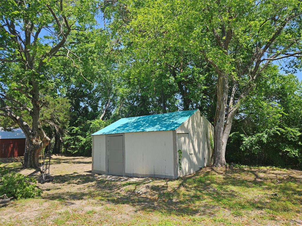234 East Fork Road Sunnyvale, TX 75182 - Photo 17 of 32 a view of backyard with a barn and large trees