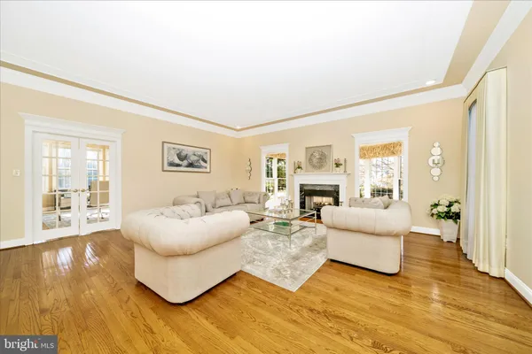 a living room with furniture and floor to ceiling windows