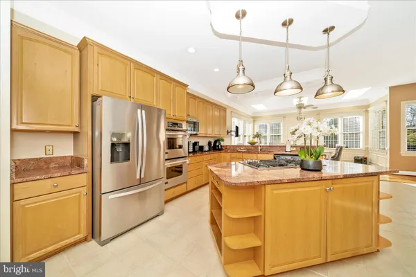 a living room with furniture and a view of kitchen