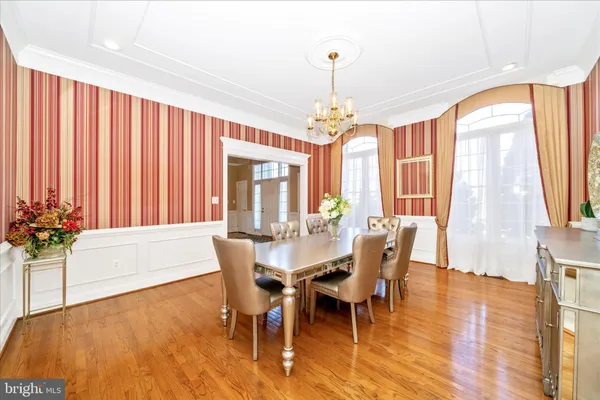 a large kitchen with kitchen island granite countertop a stove top oven a sink a dining table and chairs