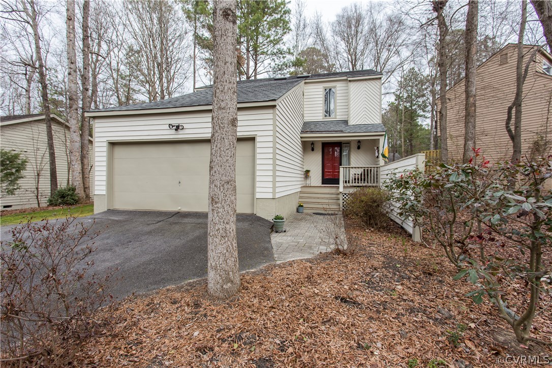 a view of a house with a yard and garage