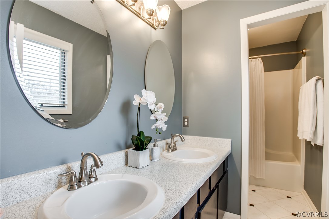 14208 Regatta Pointe Road Midlothian, VA 23112 - Photo 19 of 35 a bathroom with a sink a mirror and a shower