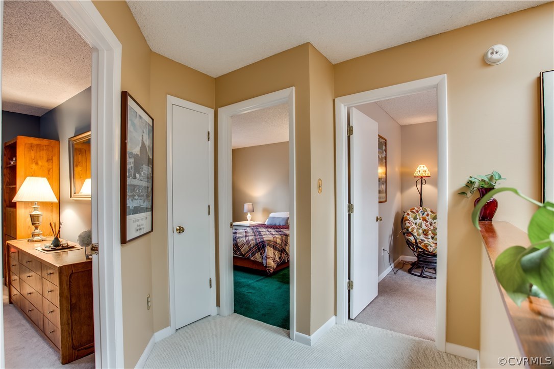 14208 Regatta Pointe Road Midlothian, VA 23112 - Photo 21 of 35 a view of a hallway to a livingroom and a dining room with a mirror