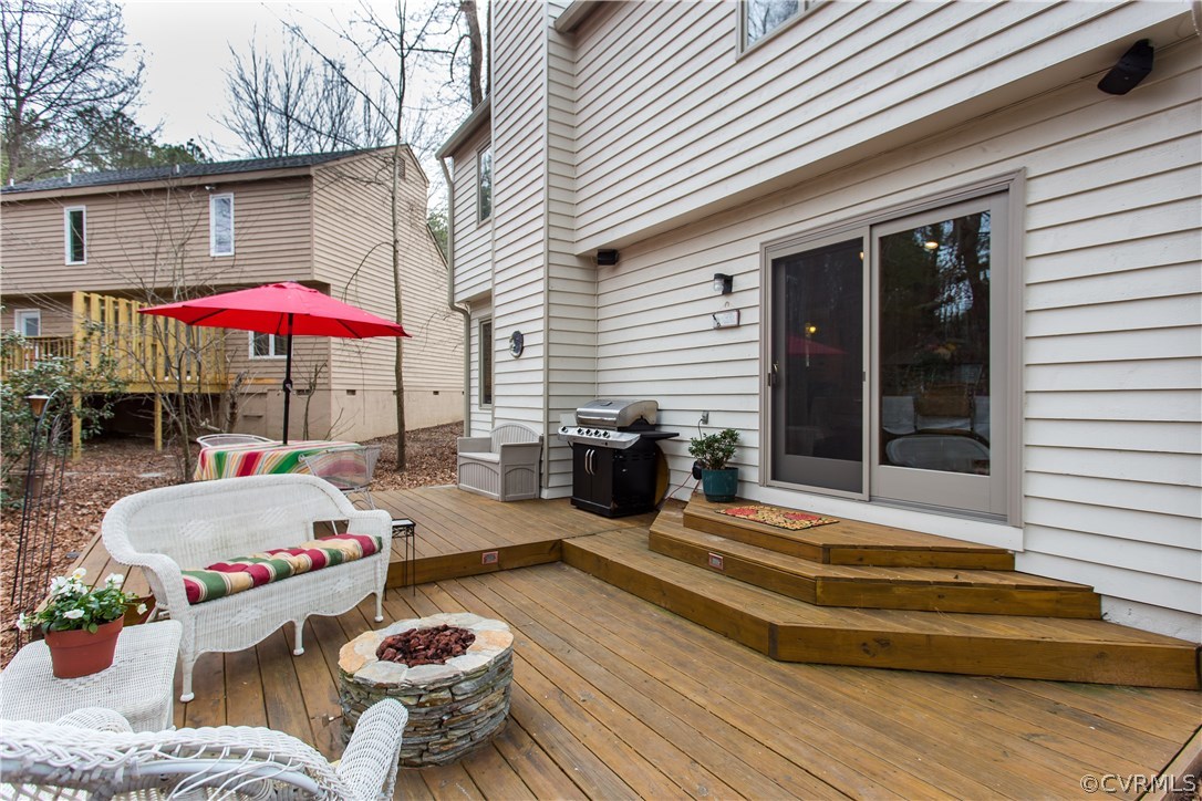 14208 Regatta Pointe Road Midlothian, VA 23112 - Photo 30 of 35 a view of a patio with couches table and chairs under an umbrella