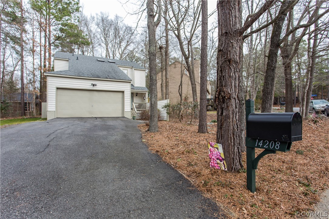 14208 Regatta Pointe Road Midlothian, VA 23112 - Photo 3 of 35 a view of a house with a yard and garage