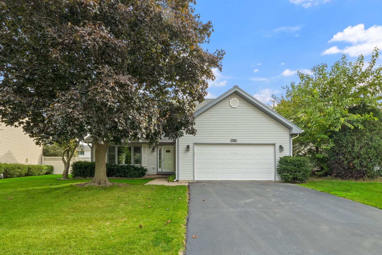 a view of a house with a yard and garage