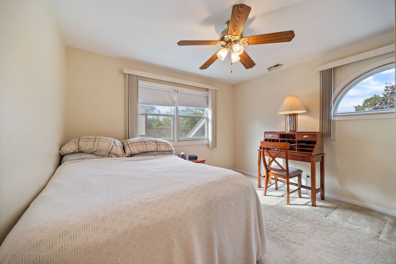 701 Garth Road Wheeling, IL 60090 - Photo 17 of 23 a bedroom with a bed and a chandelier