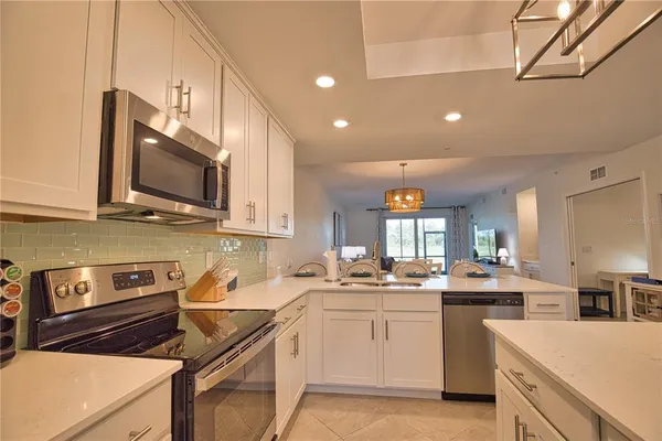 a kitchen with a sink stove top oven and cabinets