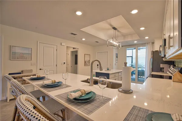 a room with furniture a table and kitchen view