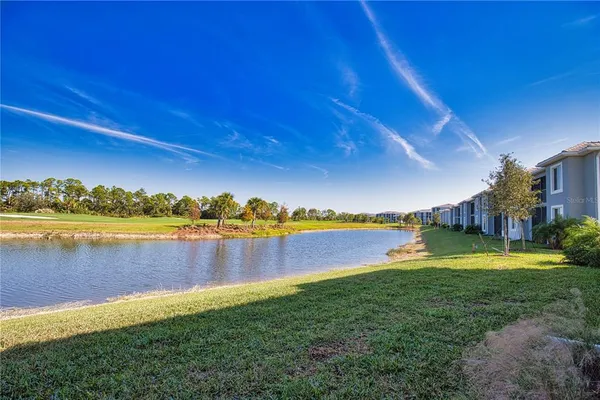 a view of a lake with houses in the back