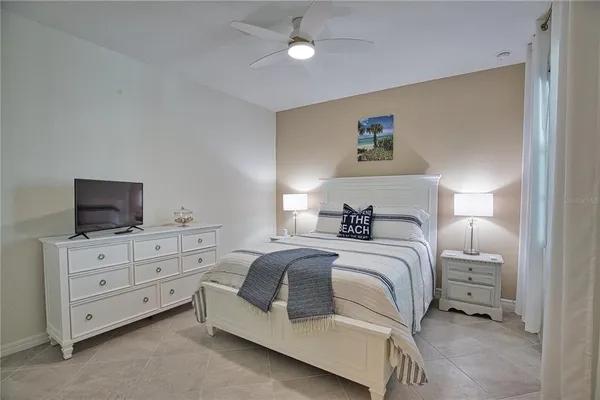 a bedroom with a bed and a television