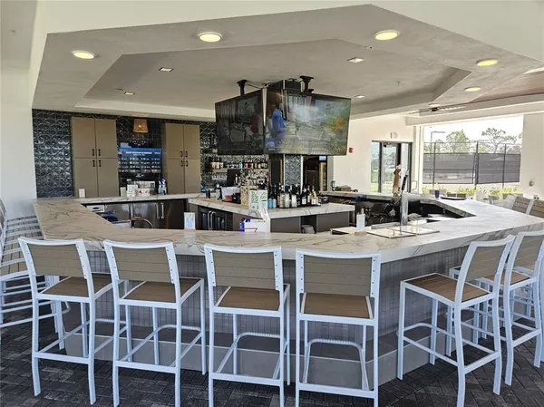 a kitchen with a dining table chairs and large window
