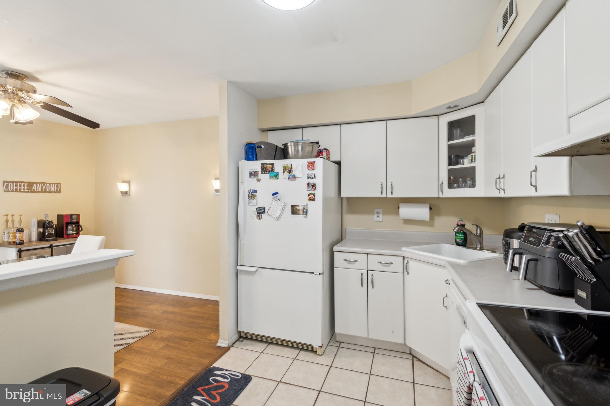 31 Sandra Road Voorhees, NJ 08043 - Photo 8 of 19 a kitchen with a sink a refrigerator and cabinets