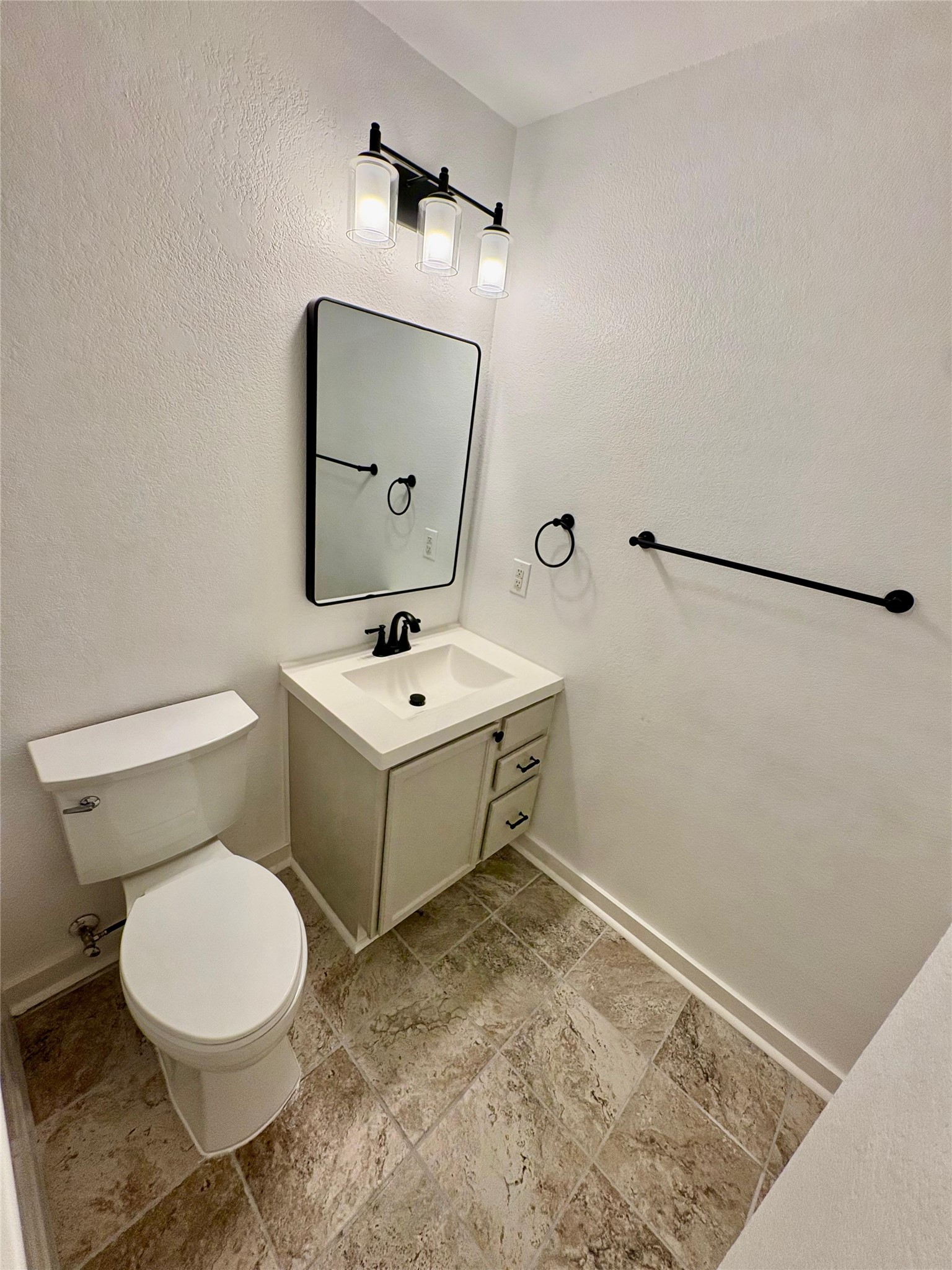 8003 Bannock Lane Austin, TX 78747 - Photo 35 of 40 Half bathroom with vanity and stone tile flooring