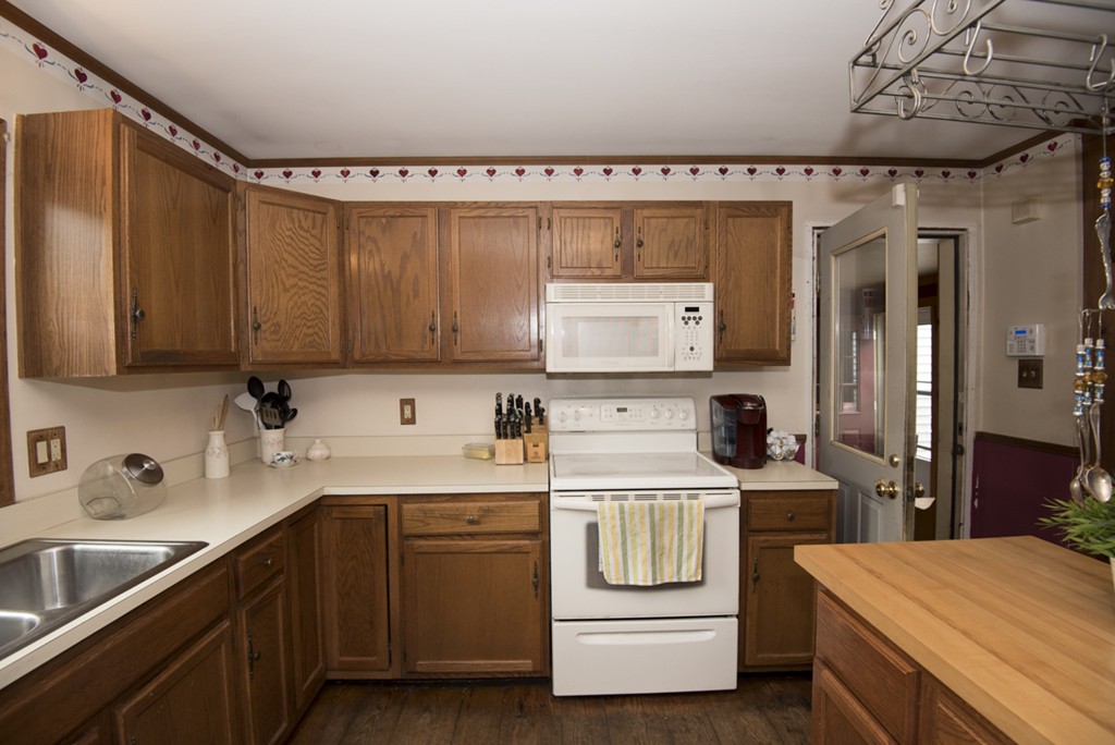 245 Stafford Road Holland, MA 01521 - Photo 8 of 30 a kitchen with a sink a stove and cabinets