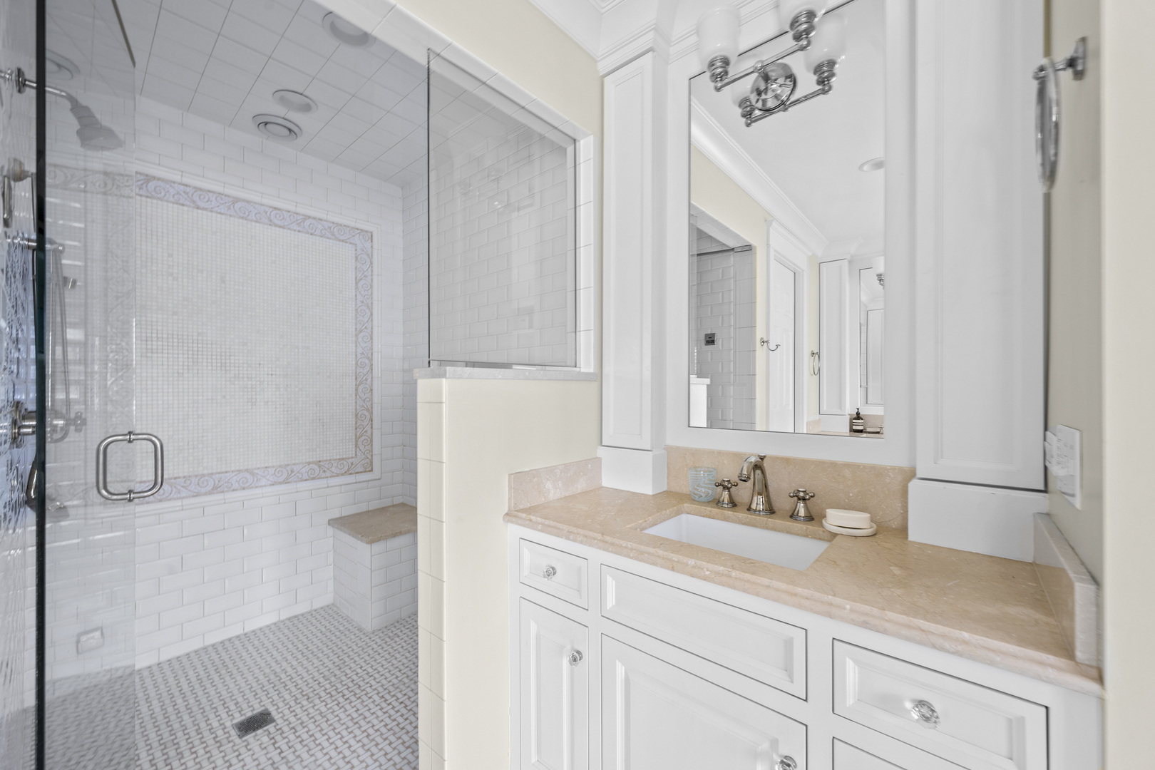 140 Birch Street Winnetka, IL 60093 - Photo 49 of 78 a bathroom with a granite countertop sink a mirror and a shower