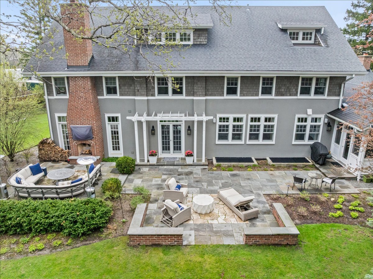 140 Birch Street Winnetka, IL 60093 - Photo 75 of 78 a view of a brick house with a yard fire pit and outdoor seating