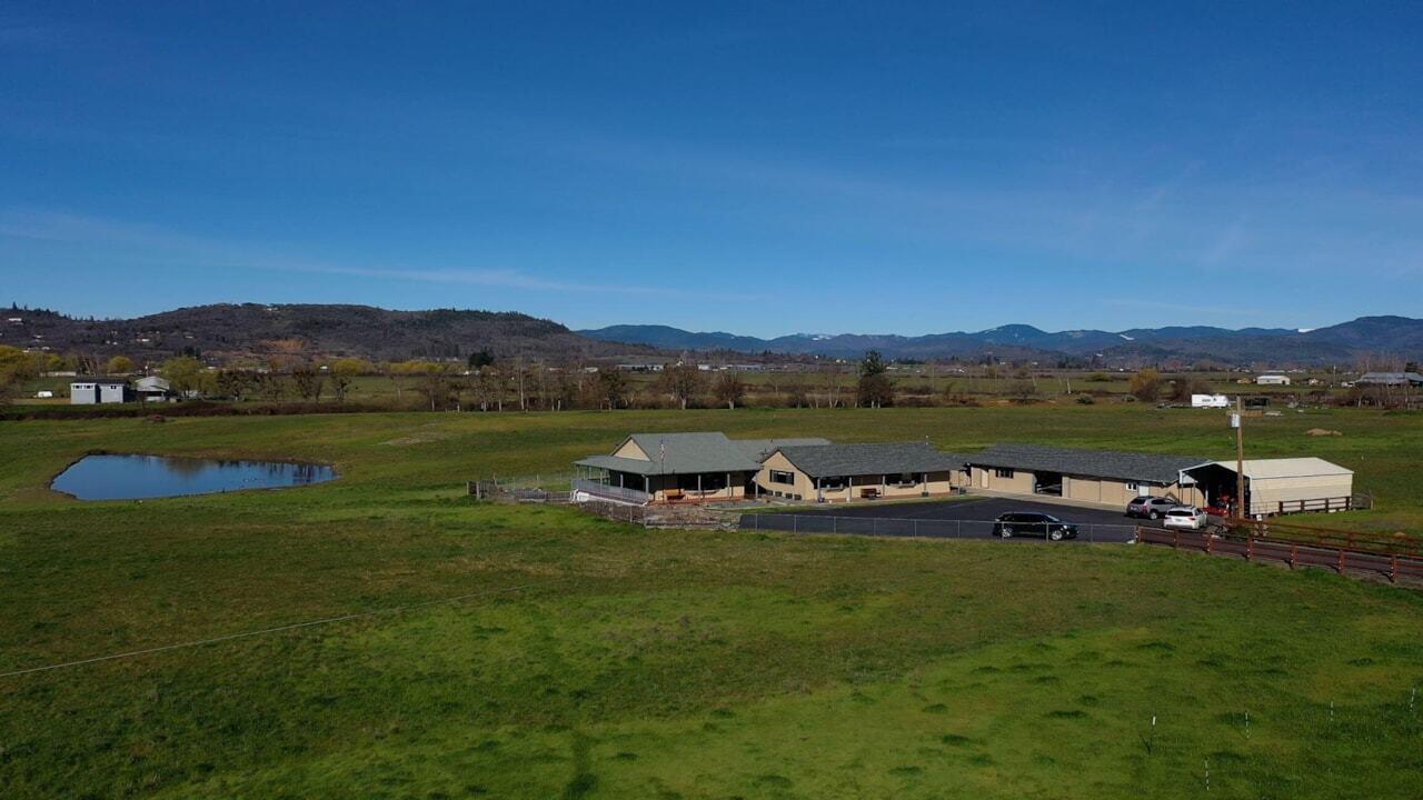 865 Reese Creek Road Eagle Point, OR 97524 - Photo 1 of 37 a view of a lake with houses in the background