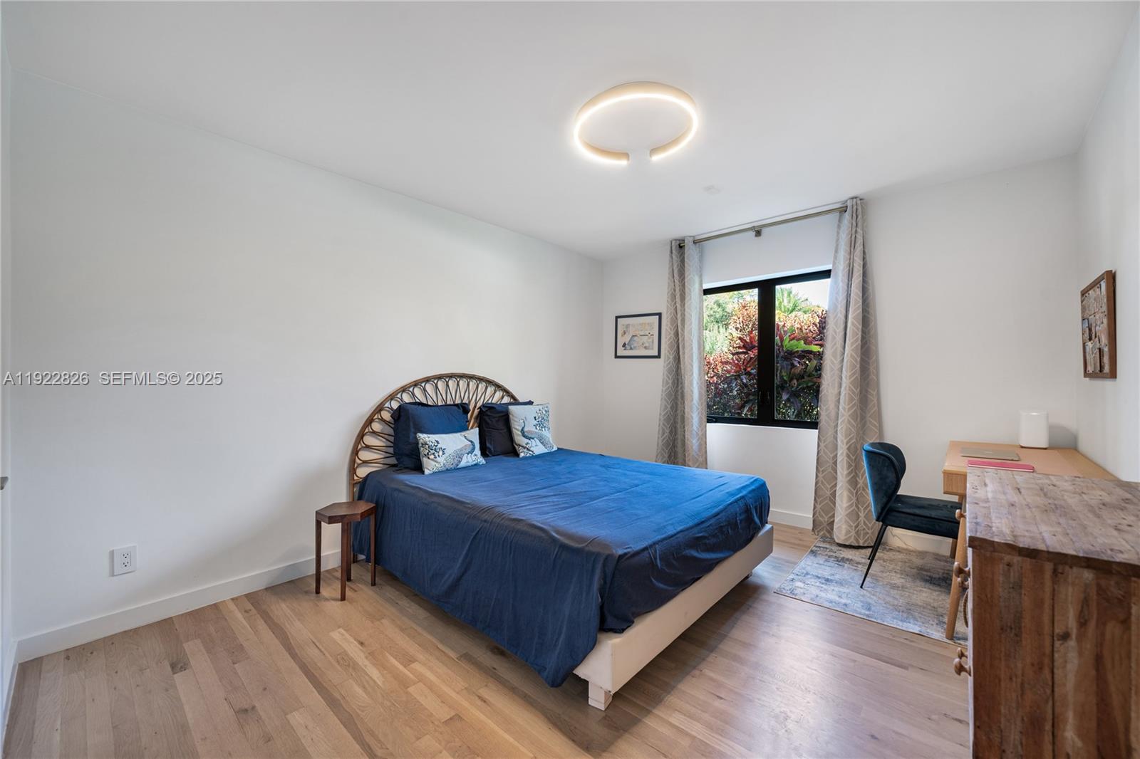 7220 Southwest 107th Terrace Pinecrest, FL 33156 - Photo 11 of 24 a bedroom with a bed and wooden floor