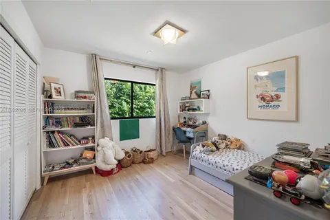 a living room with furniture and a book shelf