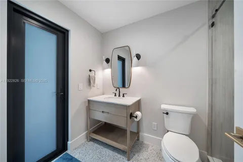 a bathroom with a toilet sink and mirror