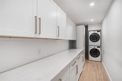 a utility room with sink dryer and washer