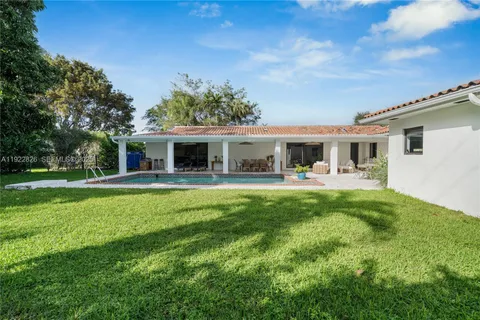 a view of house that has a yard