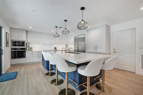 a view of a dining room with furniture wooden floor and chandelier