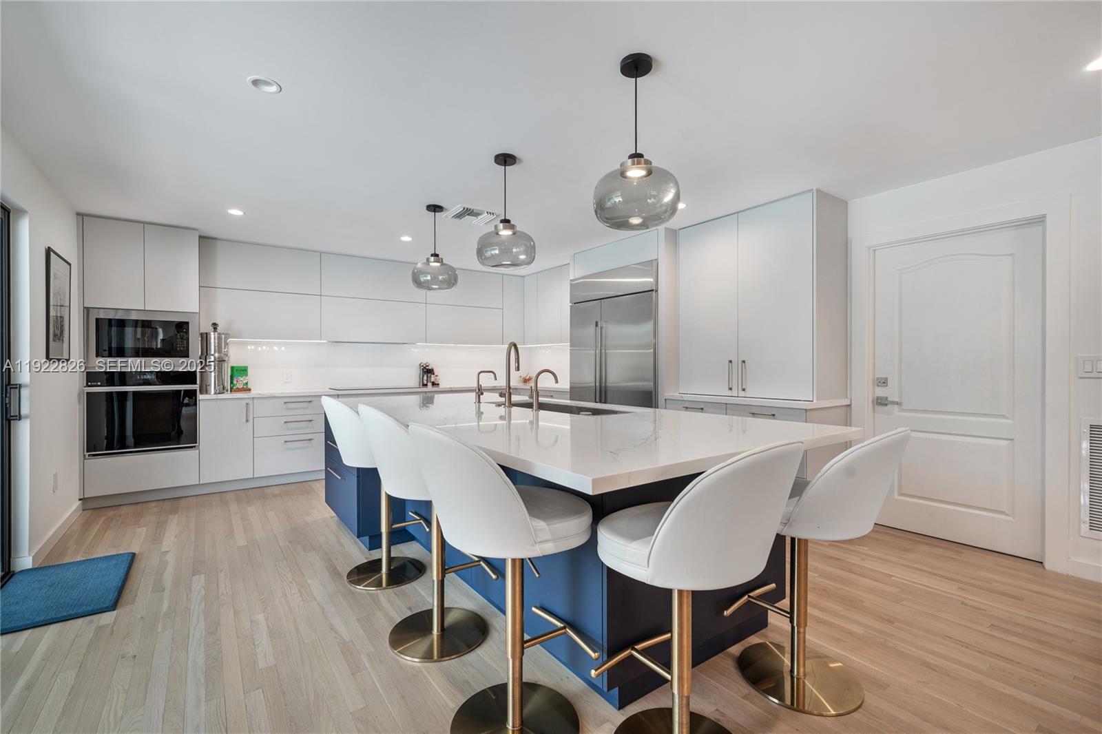 7220 Southwest 107th Terrace Pinecrest, FL 33156 - Photo 4 of 24 a view of a dining room with furniture wooden floor and chandelier