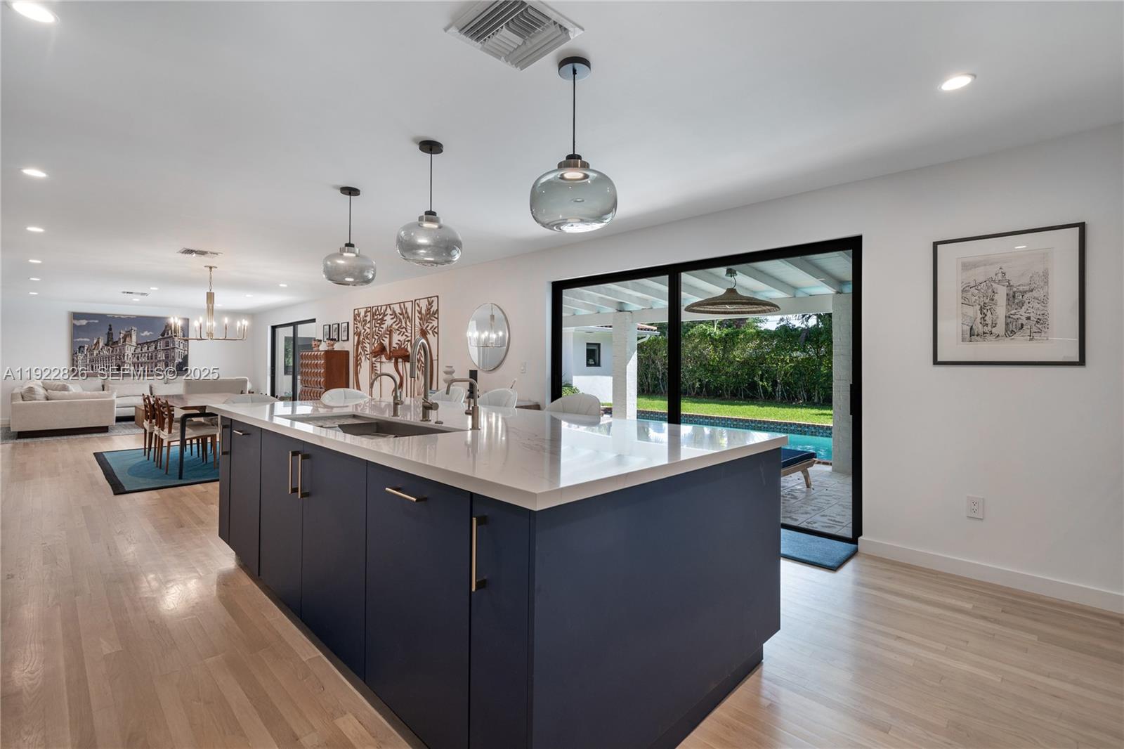 7220 Southwest 107th Terrace Pinecrest, FL 33156 - Photo 5 of 24 a kitchen with stainless steel appliances granite countertop a sink a stove top oven a wooden floor