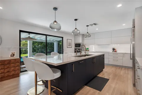 a kitchen with sink cabinets and wooden floor