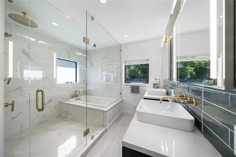 a large white kitchen with a large window