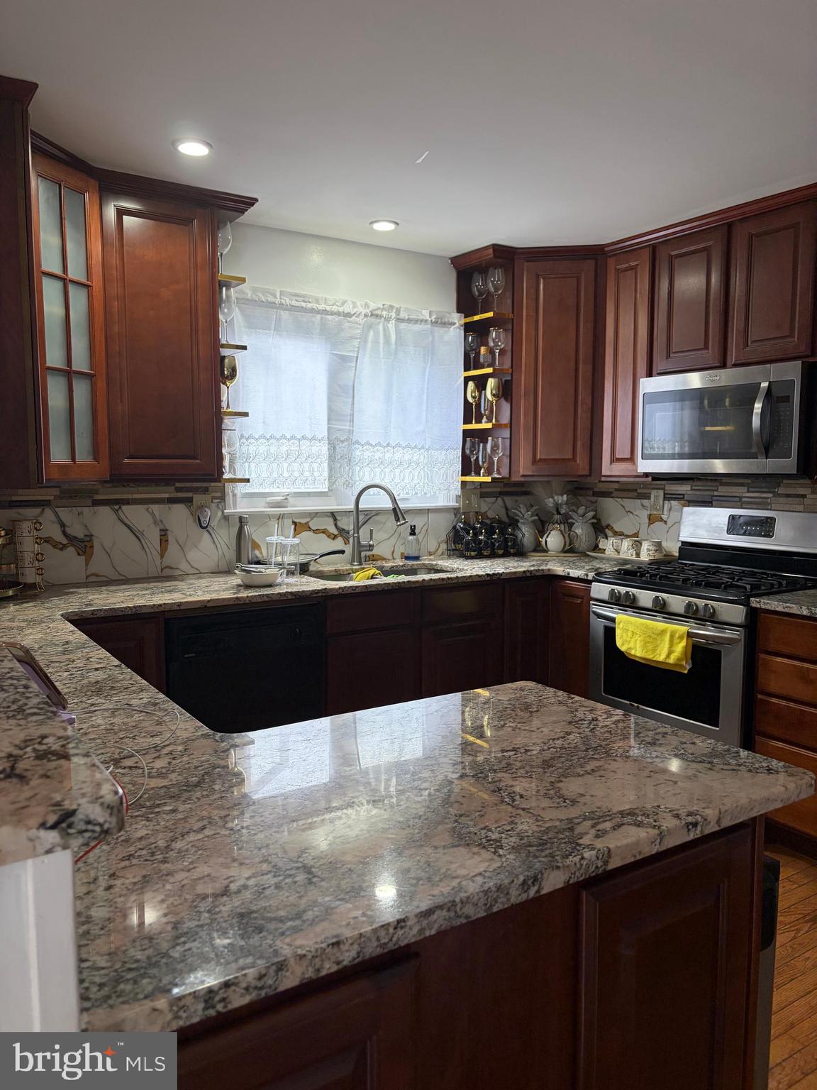 7404 Wyndam Road Pennsauken, NJ 08110 - Photo 12 of 50 a kitchen with kitchen island granite countertop a sink a stove and a microwave