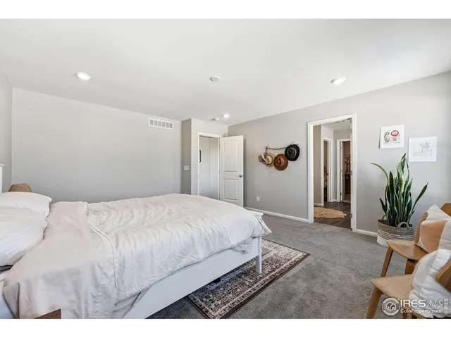 a spacious bedroom with a bed and a cabinets
