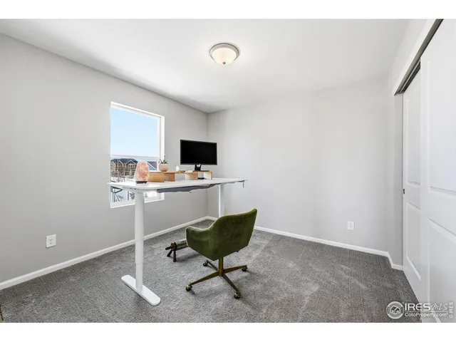 a bedroom with a bed next to a window