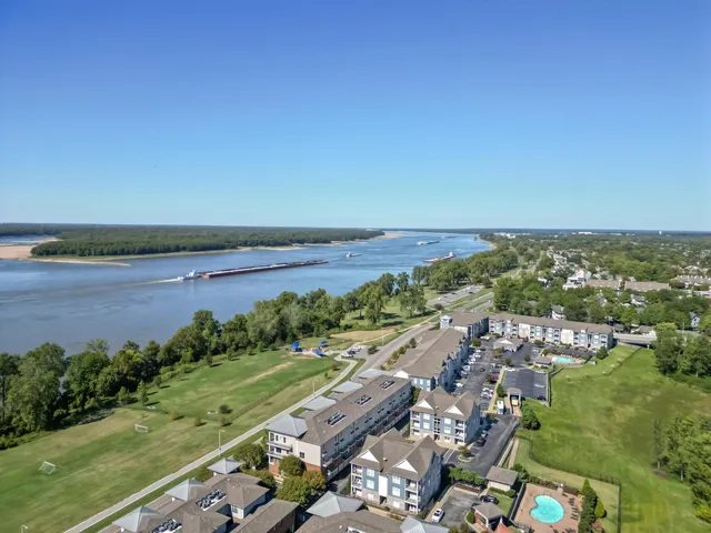 an aerial view of residential houses with outdoor space and swimming pool