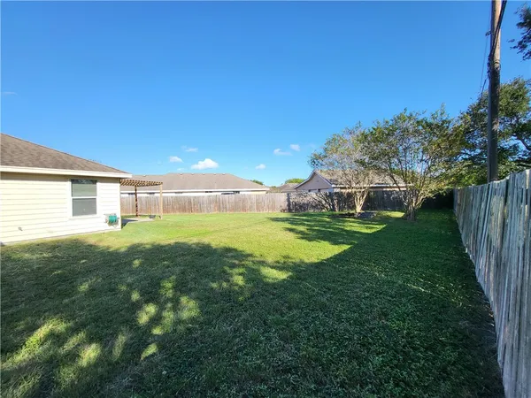a view of an house with backyard space and garden