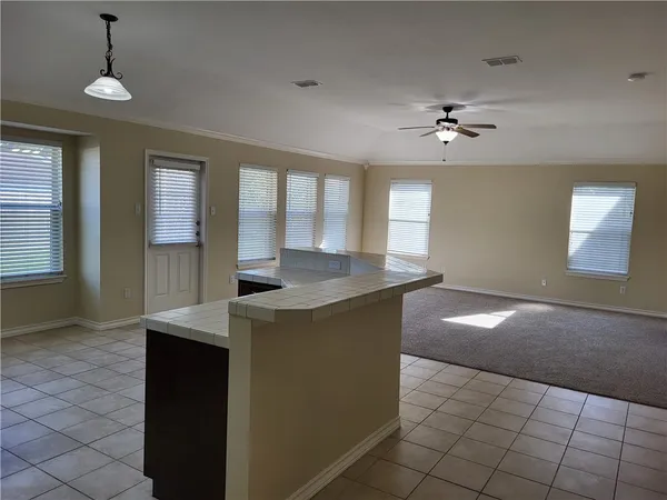 a view of a kitchen with a sink and chandelier